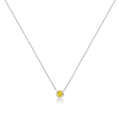 Front view of a white metal necklace with a round yellow gemstone in a bezel setting pendant.