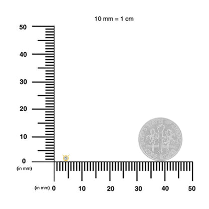 Close-up view of a yellow metal necklace pendant with a single round white gemstone in bezel setting, displayed on a ruler for size reference.