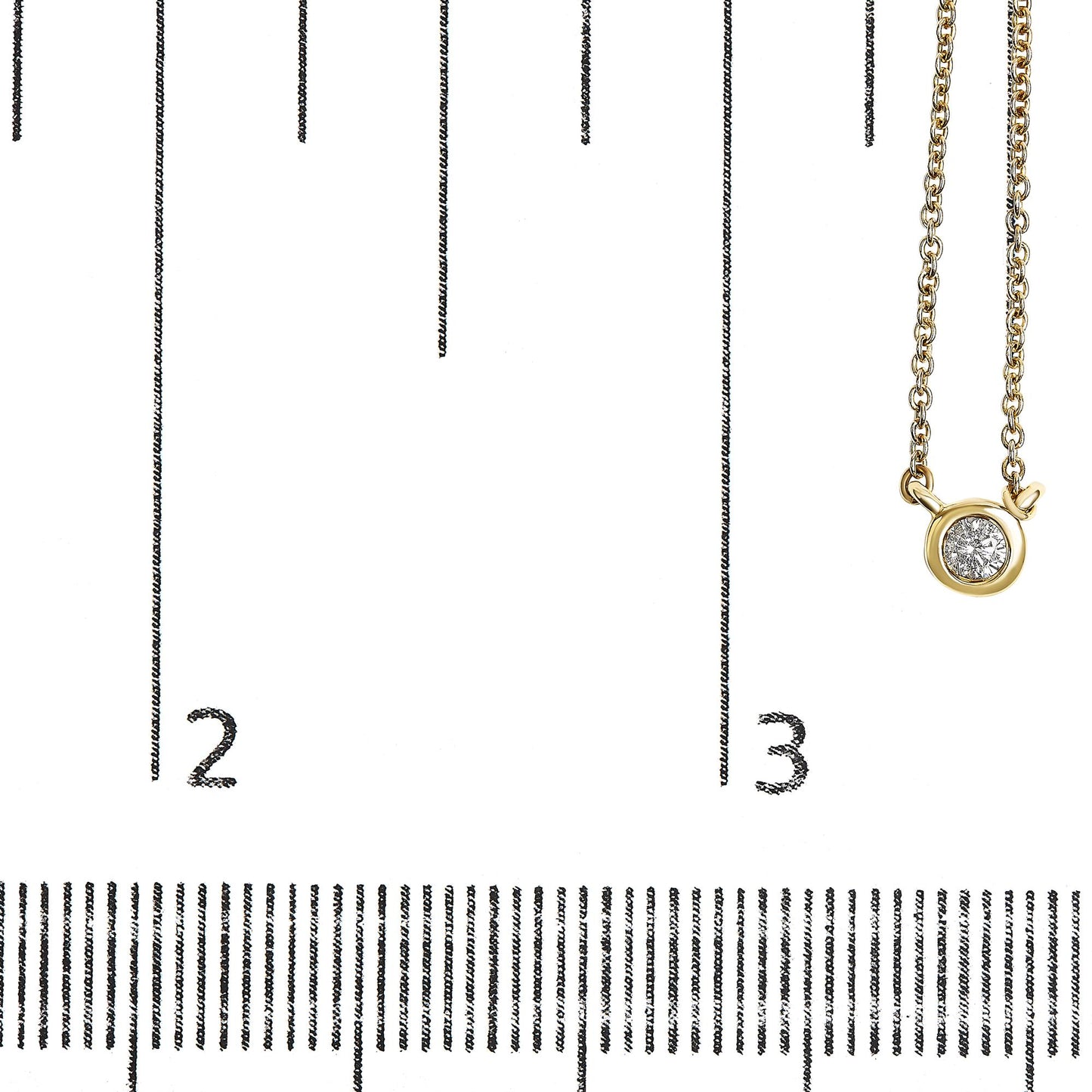 Close-up of a yellow metal necklace with a round bezel-set white gemstone pendant, displayed on a ruler for size reference.