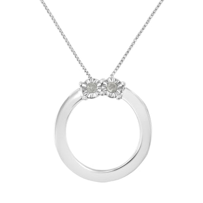 Front-facing close-up of a white metal circular necklace pendant featuring two round white gemstones in miracle settings at the top, on a matching chain.