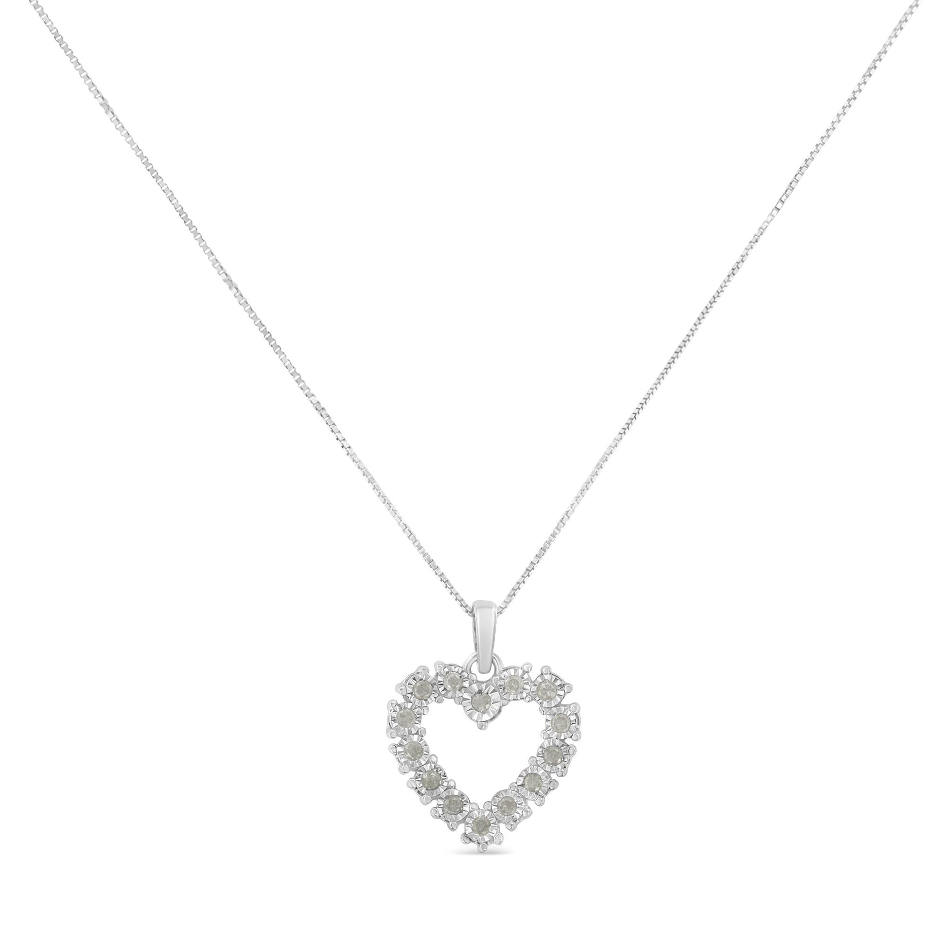 Front-facing shot of a white metal necklace with a heart-shaped pendant set with round white gemstones in a miracle setting.