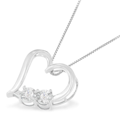 Close-up front angle of a white metal heart-shaped necklace pendant with two round white gemstones in miracle settings on a matching chain.