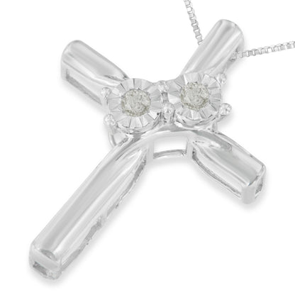 Close-up front angle of a white metal cross necklace pendant with two round white gemstones in miracle settings at the top, attached to a fine chain.
