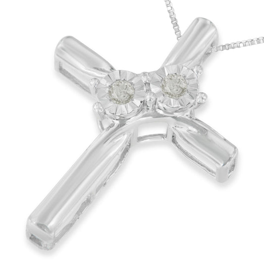 Close-up front angle of a white metal cross necklace pendant with two round white gemstones in miracle settings at the top, attached to a fine chain.