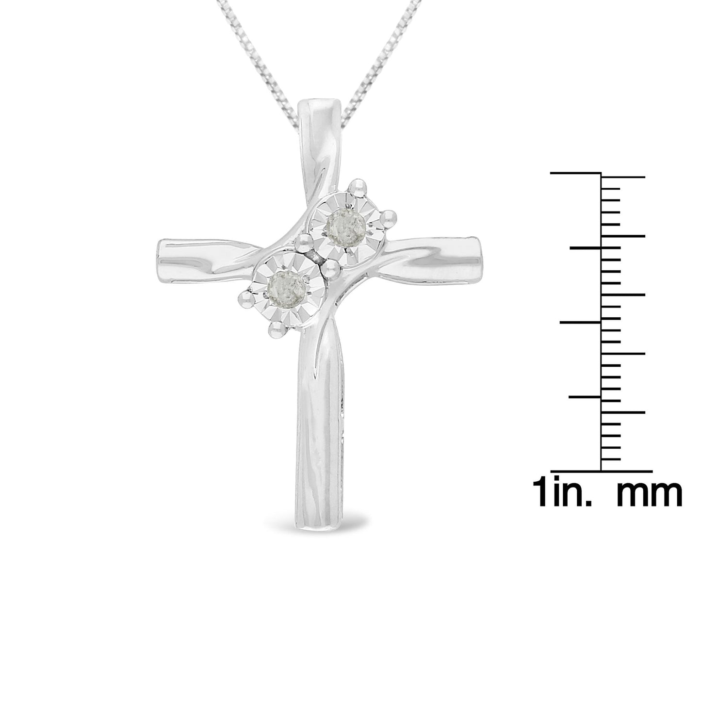 Front view of a white metal cross necklace with two round white gemstones in miracle settings, displayed next to a ruler for size reference.