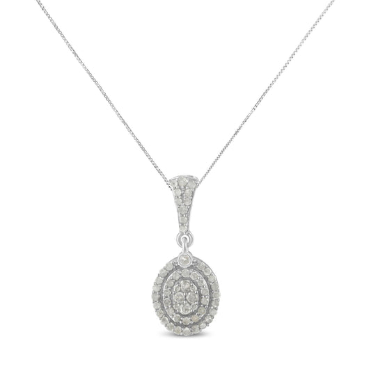 Front-facing shot of a white metal necklace with an oval pendant adorned with multiple round white gemstones in prong settings.