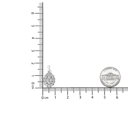 White necklace pendant with multiple round white gemstones in prong settings, photographed on a ruler and next to a coin for size reference, front view.