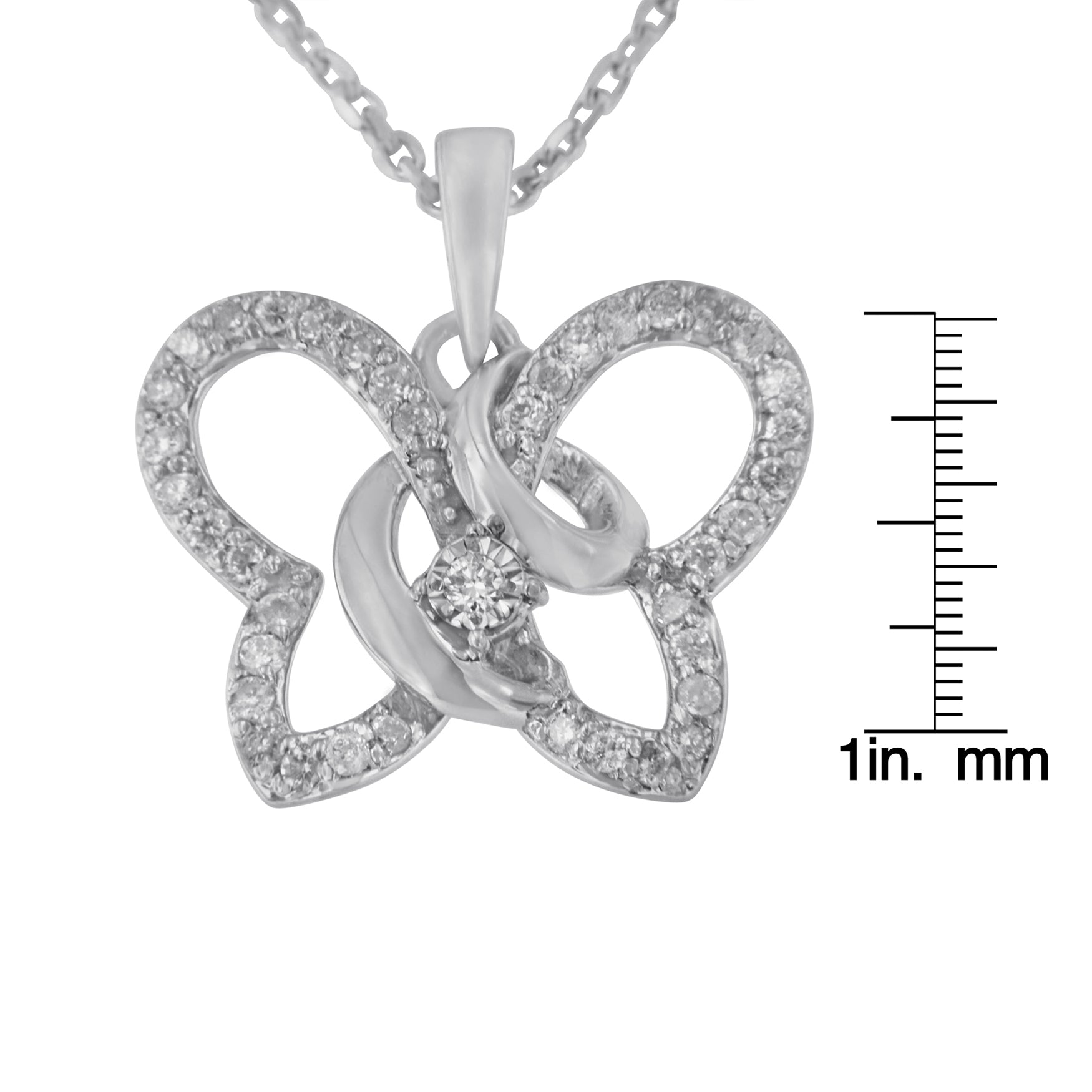 White metal butterfly-shaped necklace pendant with multiple round white gemstones in prong settings, shown close-up with a size ruler, photographed from the front.