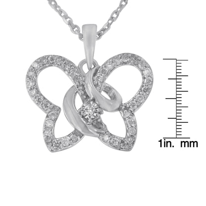 White metal butterfly-shaped necklace pendant with multiple round white gemstones in prong settings, shown close-up with a size ruler, photographed from the front.