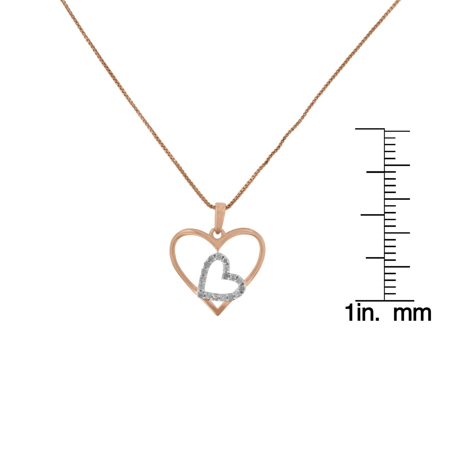 Front view of a yellow and white metal heart-shaped necklace with a smaller heart accented by white gemstones, displayed next to a ruler for size reference.