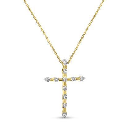 Front view of a yellow metal cross necklace pendant with round white gemstones in a miracle setting, hanging from a chain.