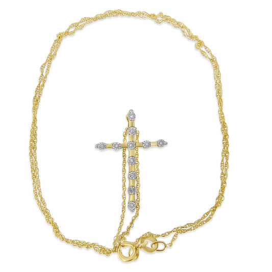 Yellow metal necklace with a cross-shaped pendant featuring round white gemstones in a miracle setting, shot from above.