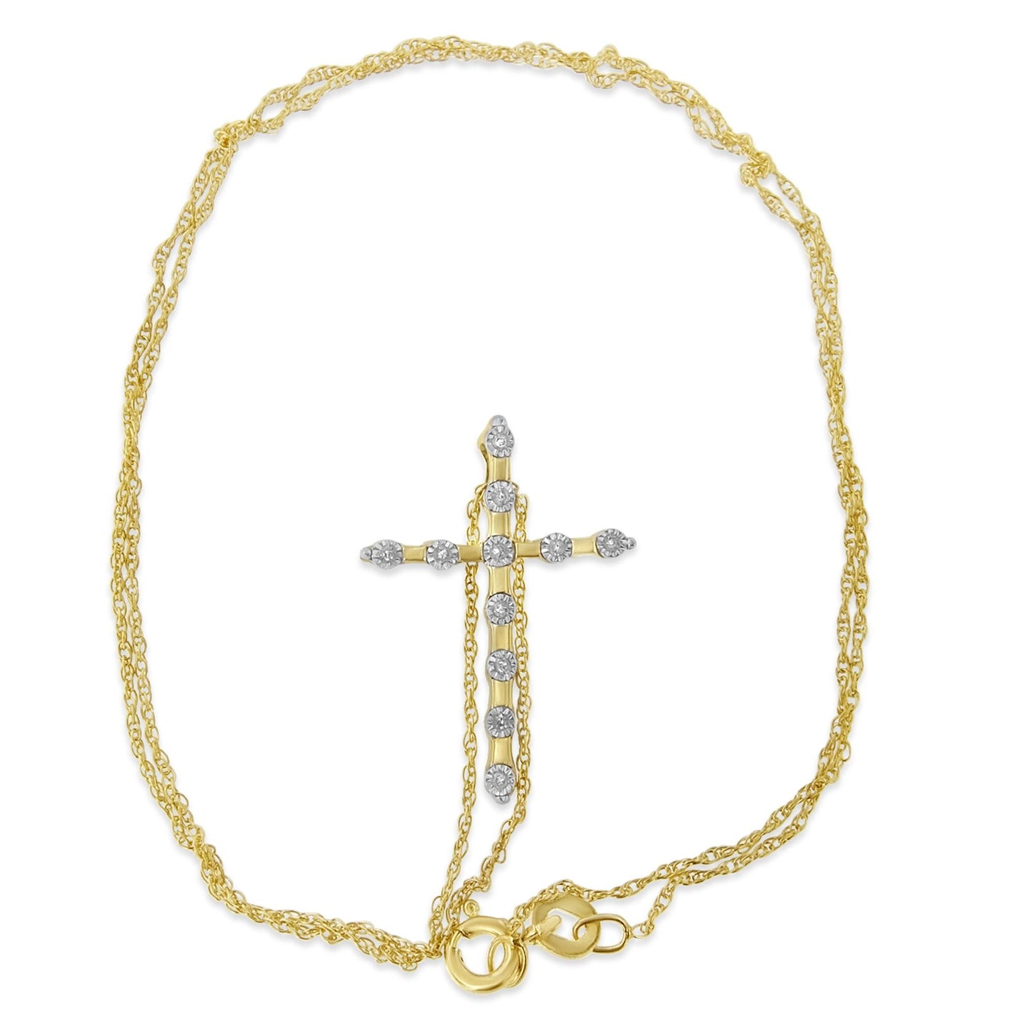 Yellow metal necklace with a cross-shaped pendant featuring round white gemstones in a miracle setting, shot from above.