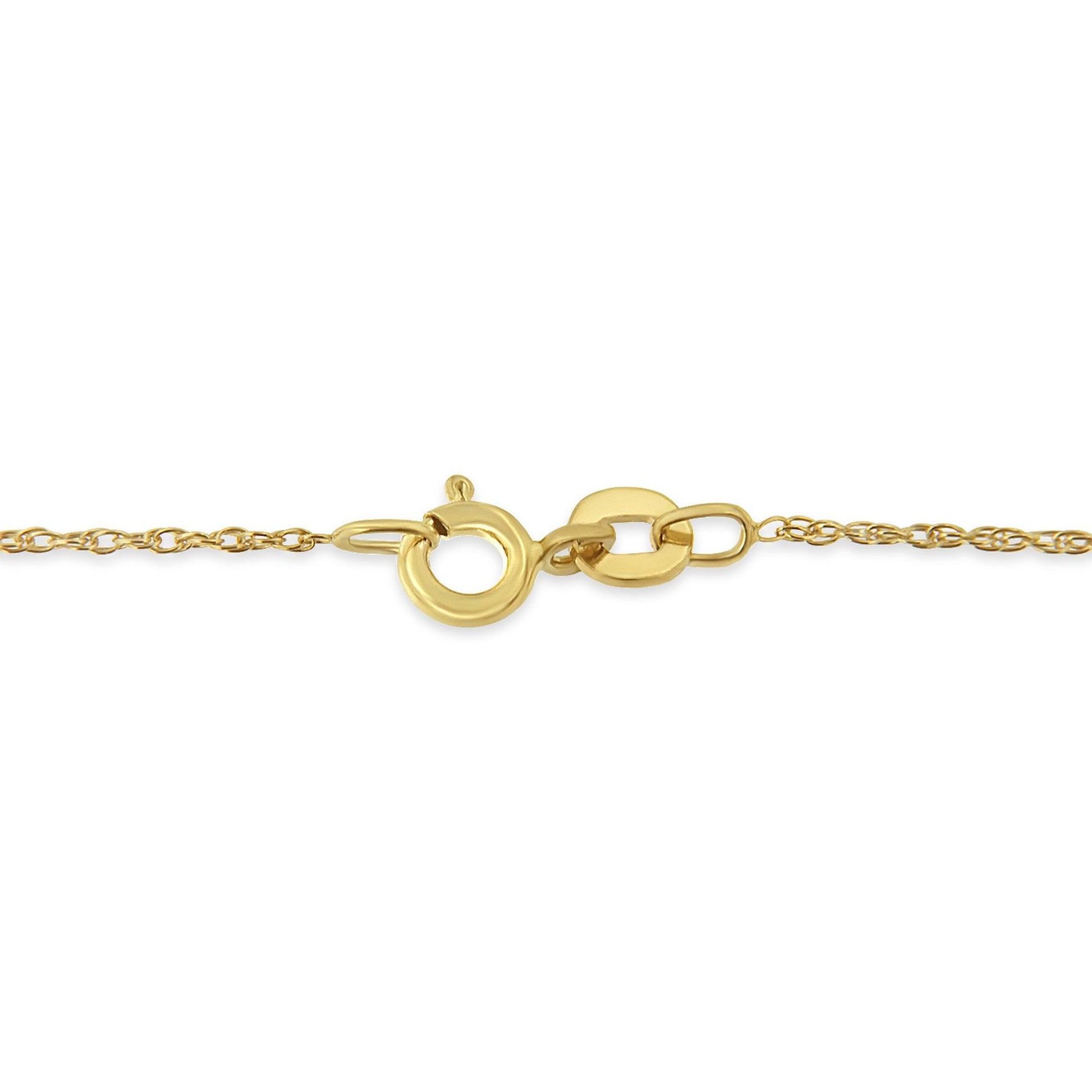 Close-up side angle of a yellow metal necklace chain with a circular clasp.