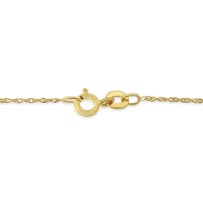 Close-up side angle of a yellow metal necklace chain with a circular clasp.