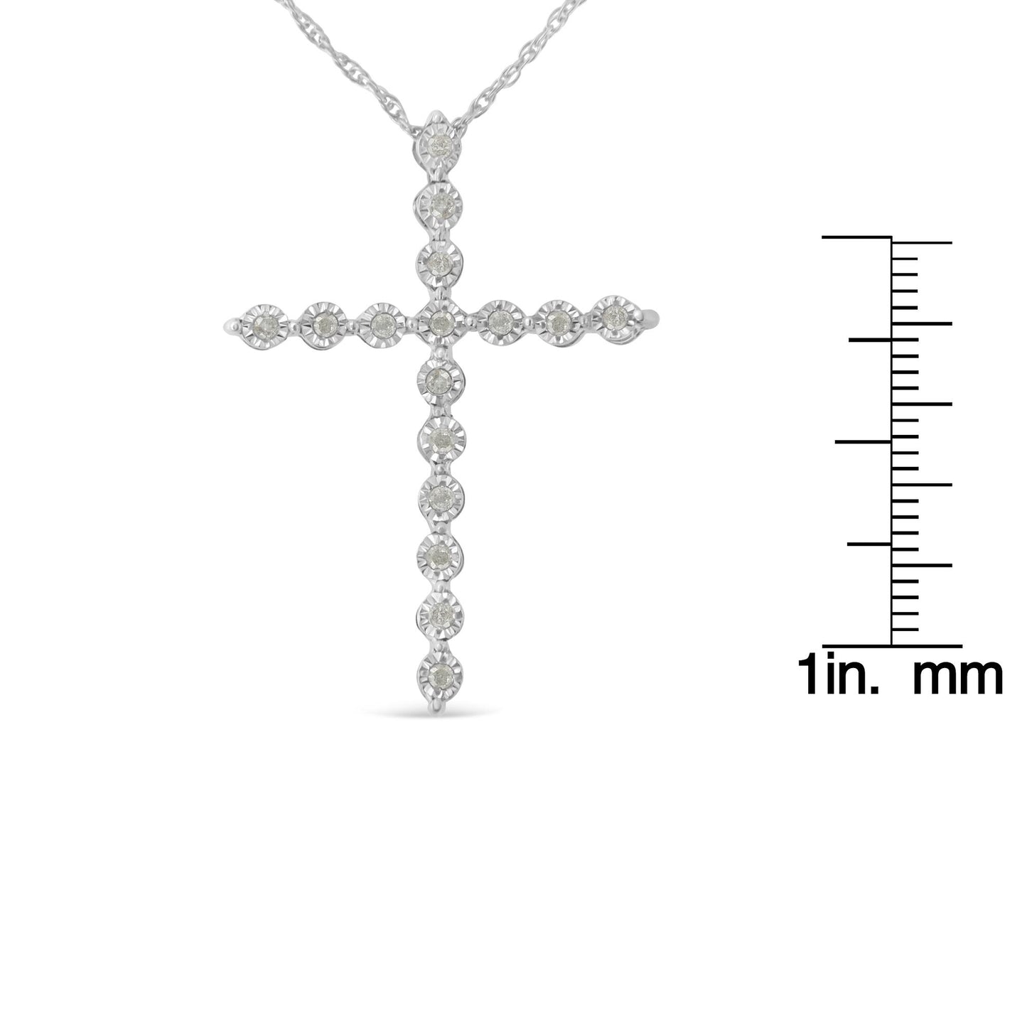 Front view of white necklace cross pendant with round white gemstones in a miracle setting, shown next to a ruler for size reference.
