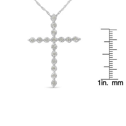 Front view of white necklace cross pendant with round white gemstones in a miracle setting, shown next to a ruler for size reference.
