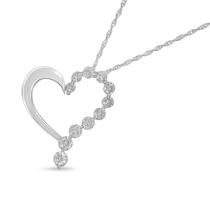 White metal heart-shaped necklace pendant with round white gemstones in a miracle setting, photographed at a slight front angle.