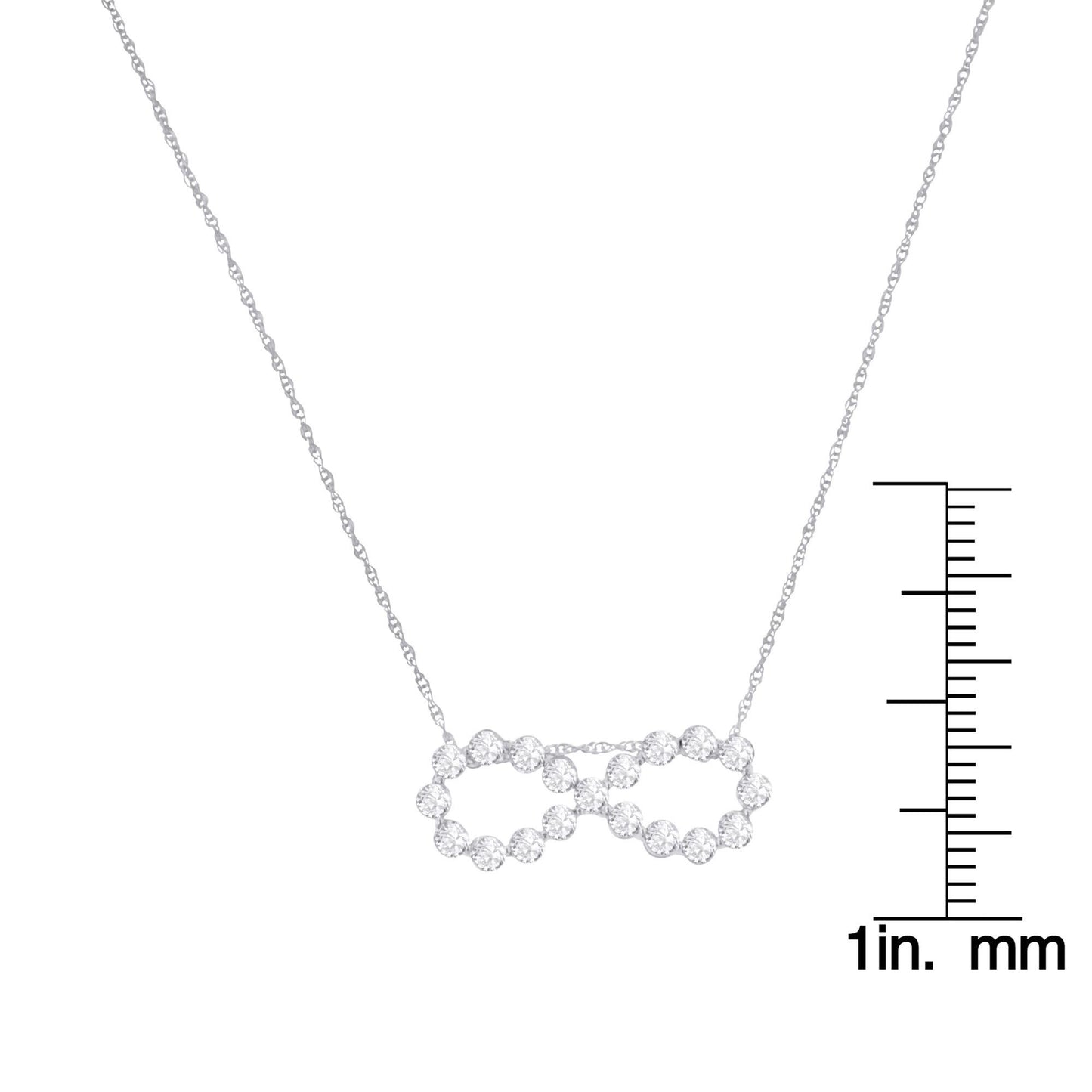 White metal necklace with an infinity shaped pendant set with round white gemstones in a miracle setting, shown from the front with a ruler for size reference.