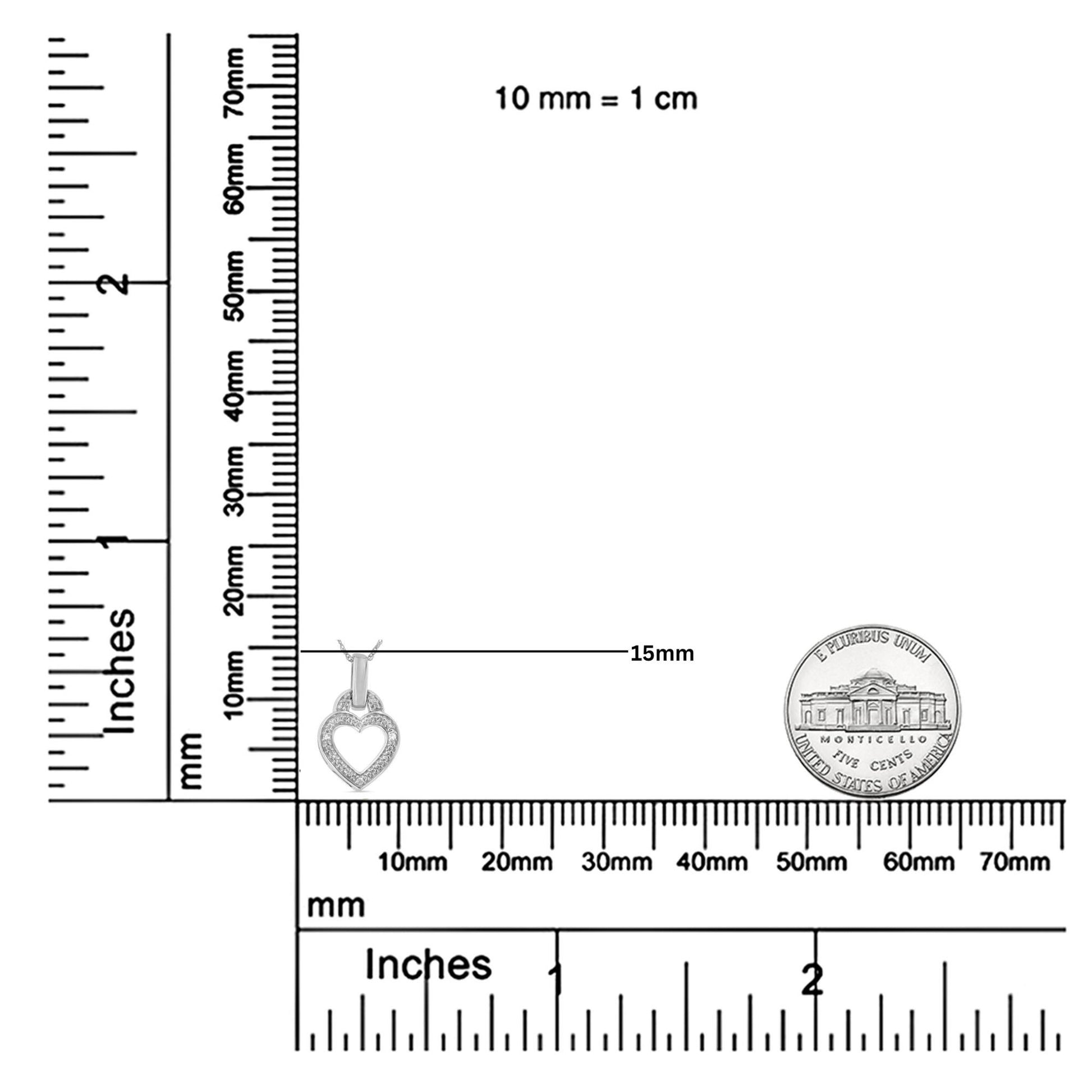 White heart-shaped necklace pendant with round white gemstones in pave setting, shown on a ruler for size reference, front angle.
