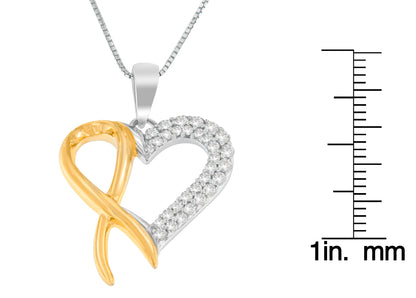 Close-up front view of a two-toned heart-shaped necklace pendant with one side smooth and yellow-toned and the other side white-toned set with round white gemstones, shown on a scale for size reference.
