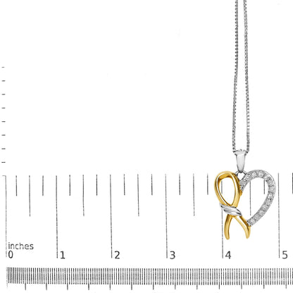 Close-up front angle of a two-tone yellow and white metal heart-shaped necklace pendant with white round prong-set gemstones, displayed on a ruler for size reference.