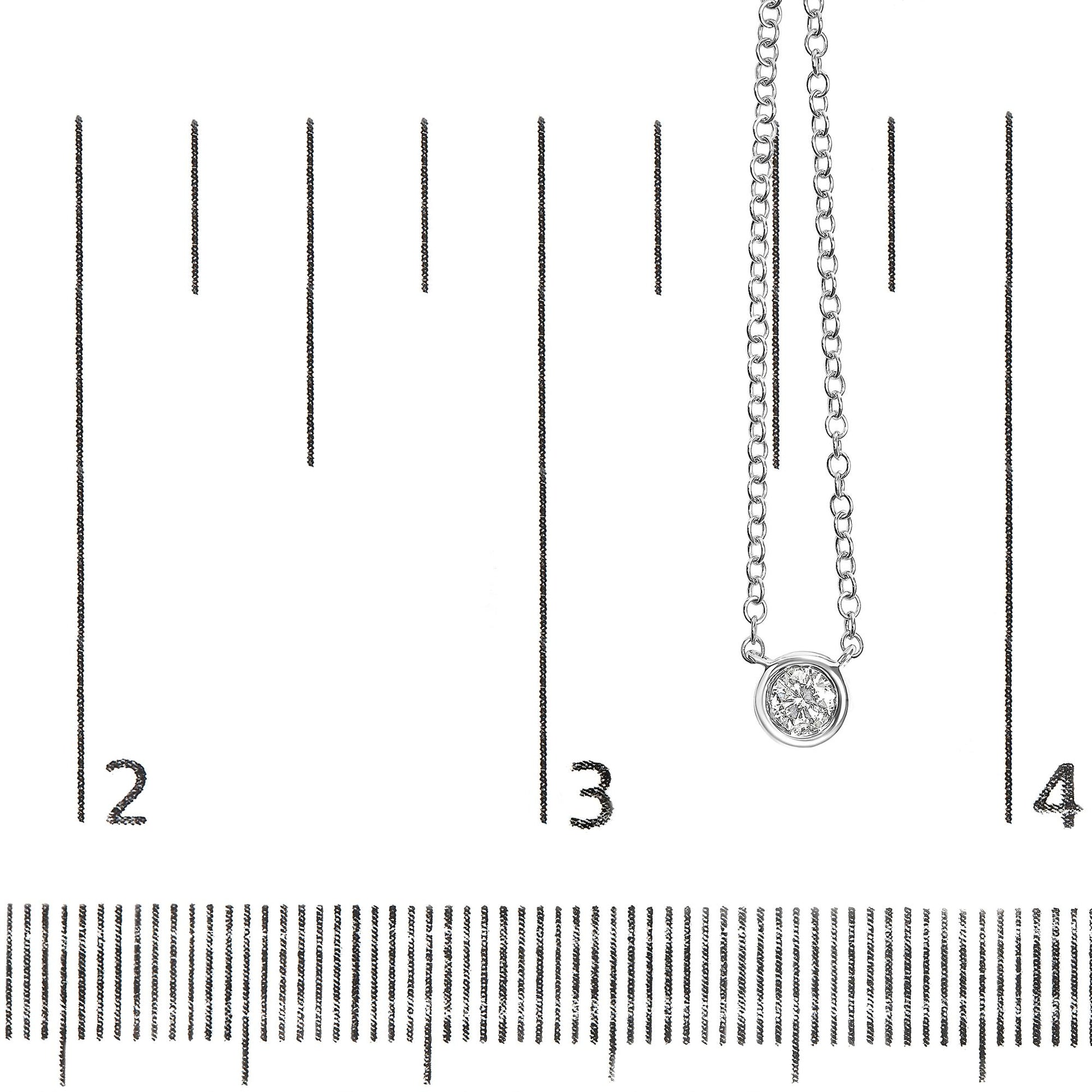 Close-up front angle of a white metal necklace with a round white gemstone in bezel setting, displayed on a ruler for size reference.