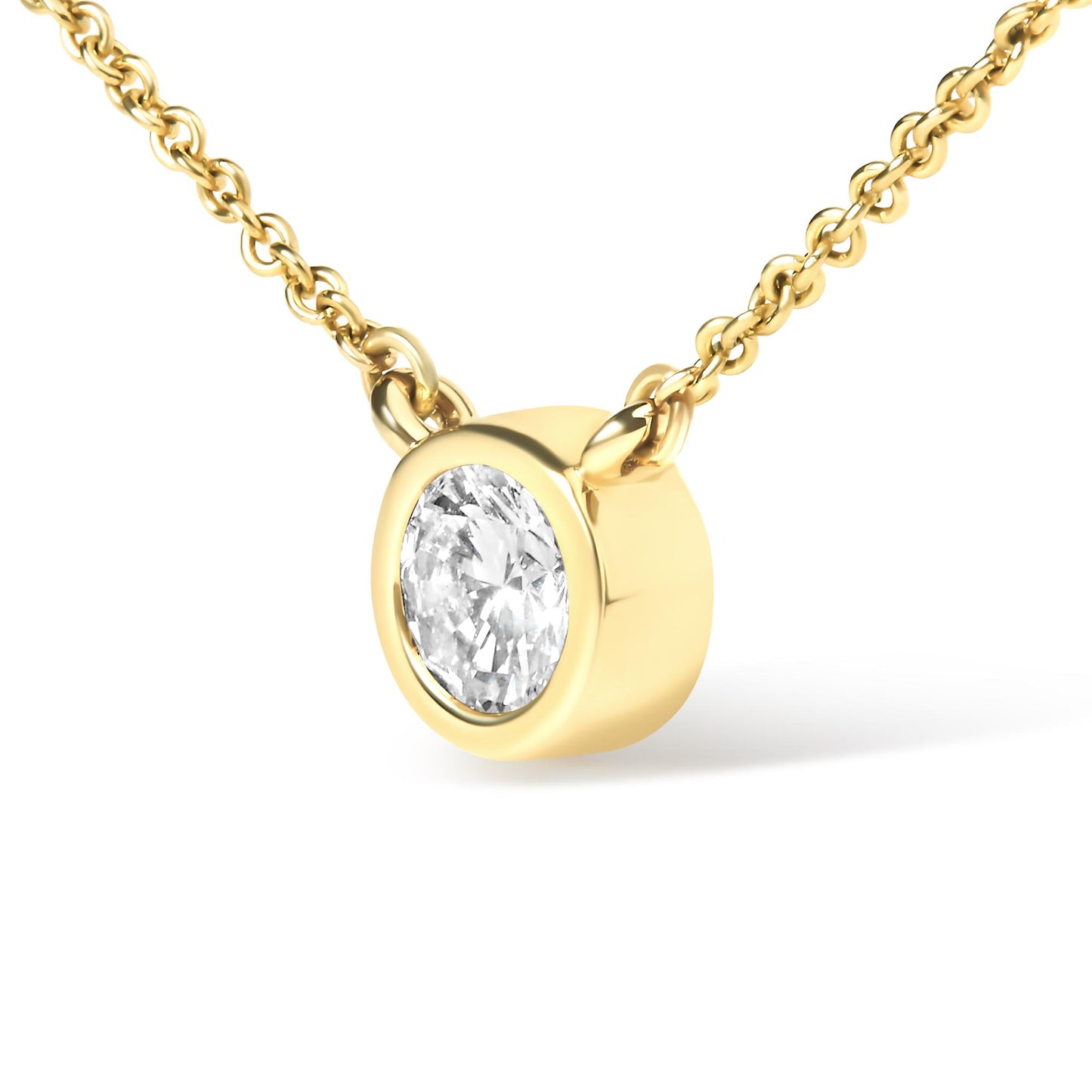 Close-up front angled view of a yellow metal necklace with a round white gemstone in a bezel setting pendant.