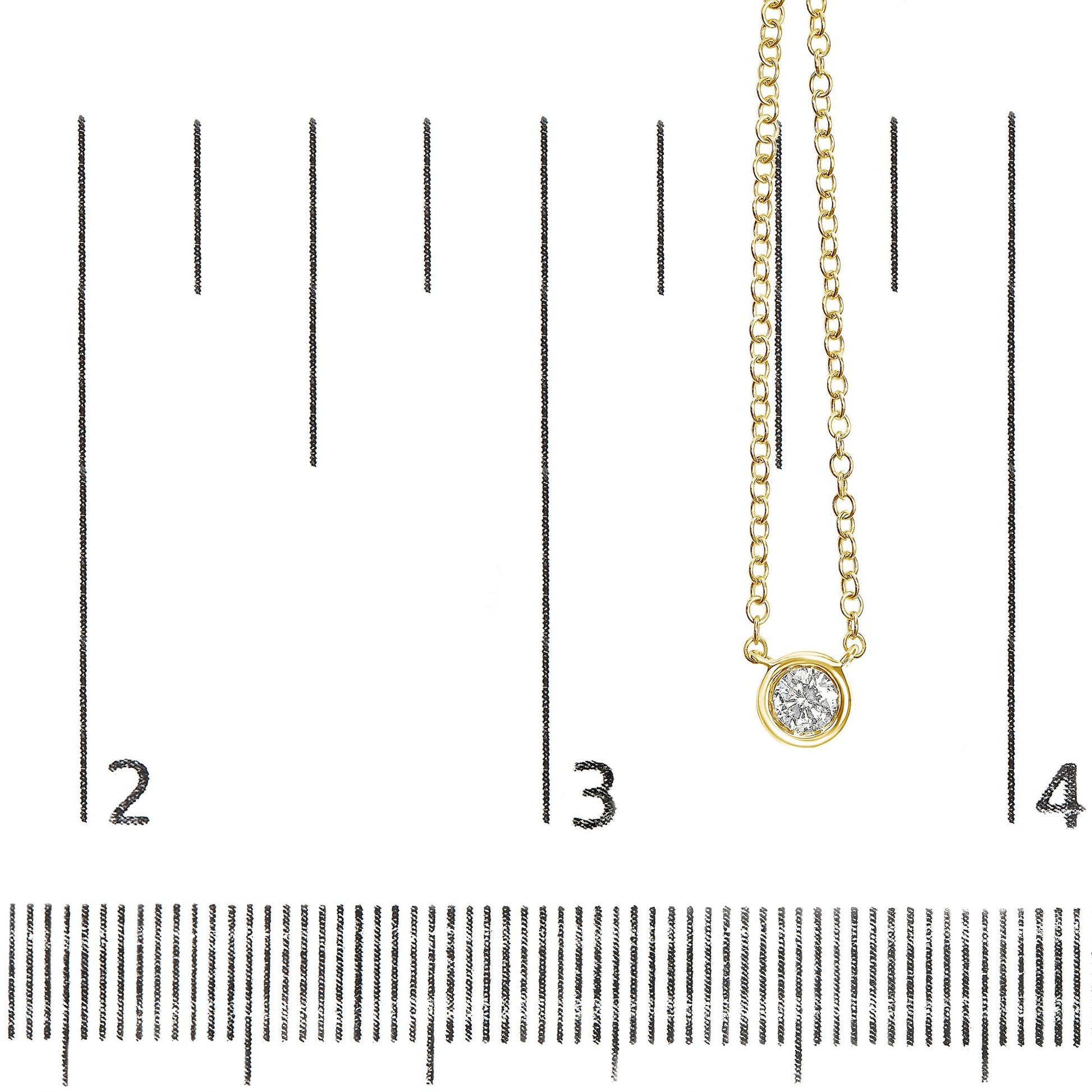 Close-up front view of a yellow metal necklace with a round white gemstone in bezel setting, displayed on a ruler for size reference.