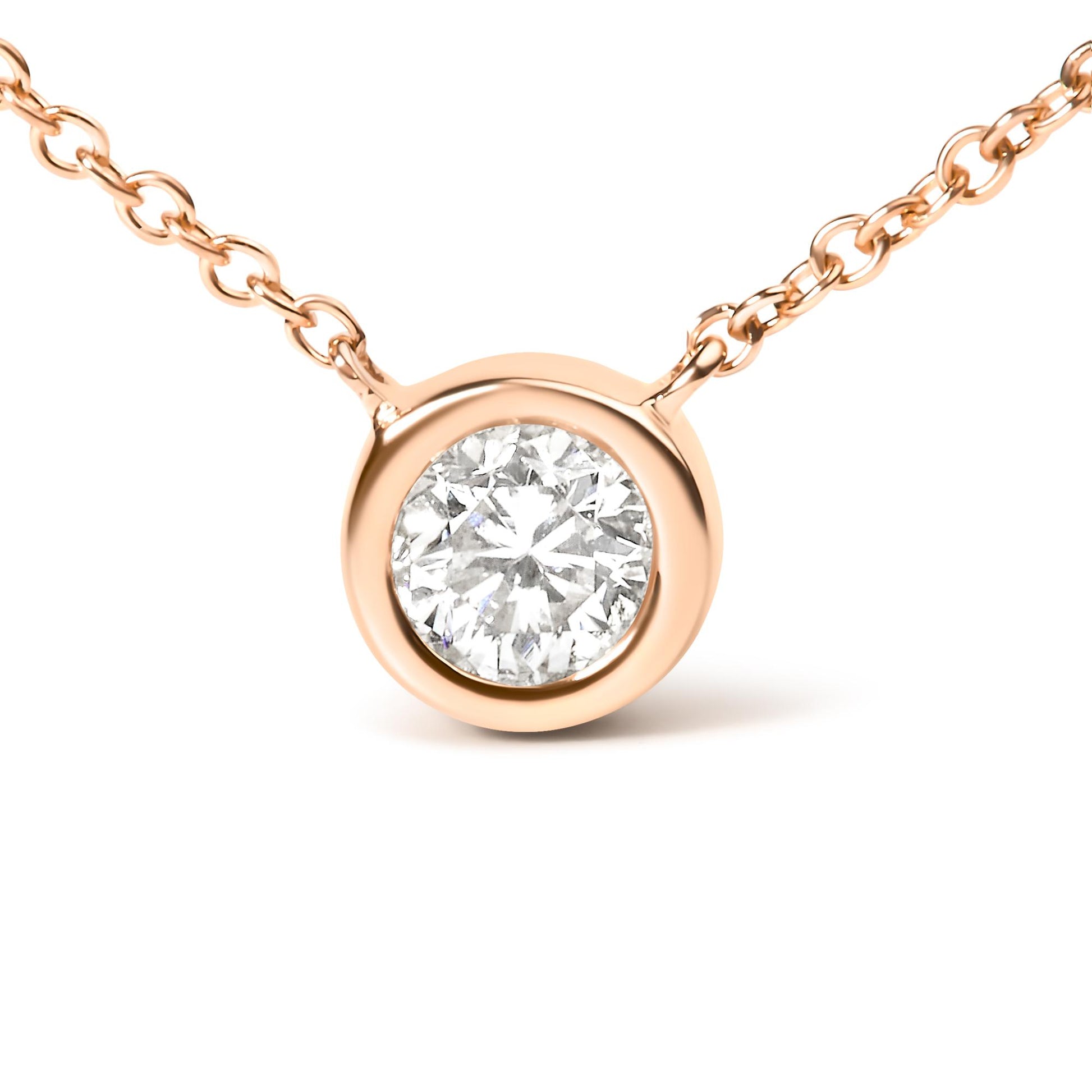 Close-up front view of a rose-colored necklace with a round white gemstone in bezel setting.