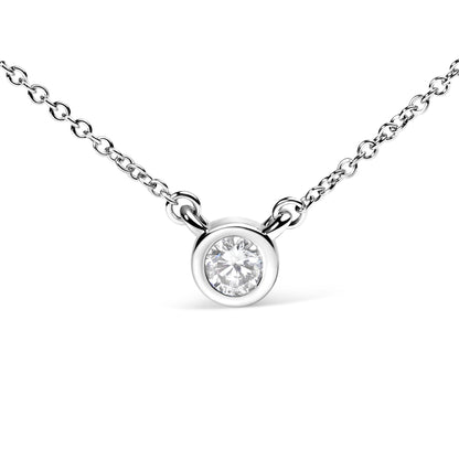 Close-up front angle of a white metal necklace with a round white gemstone in a bezel setting.