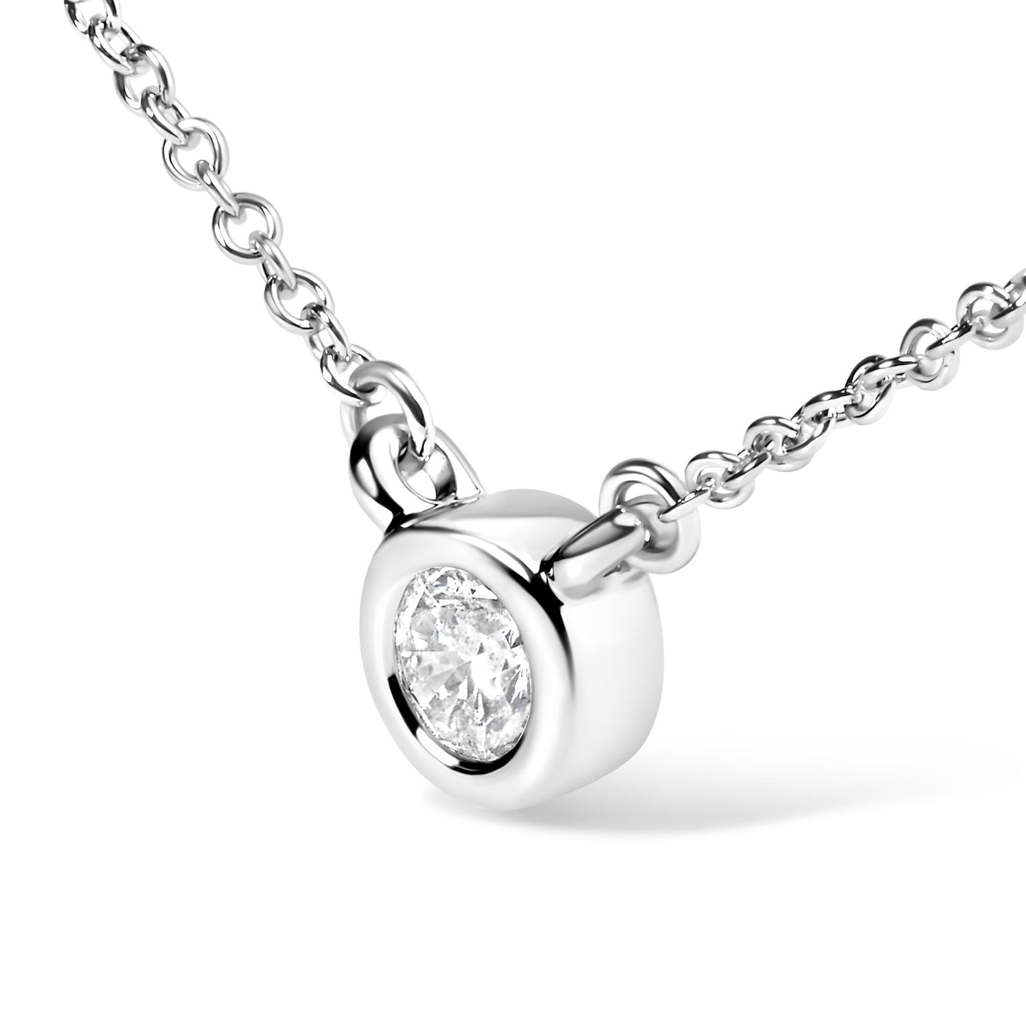 Close-up front angle of a white metal necklace featuring a round bezel-set white gemstone pendant.