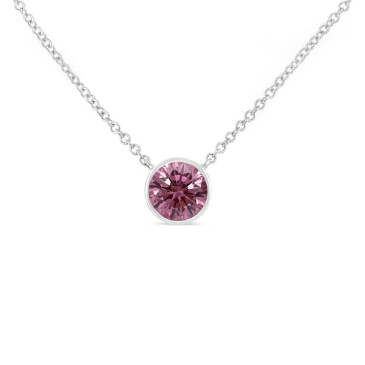 Front-facing shot of a white necklace with a round pink gemstone in a bezel setting.
