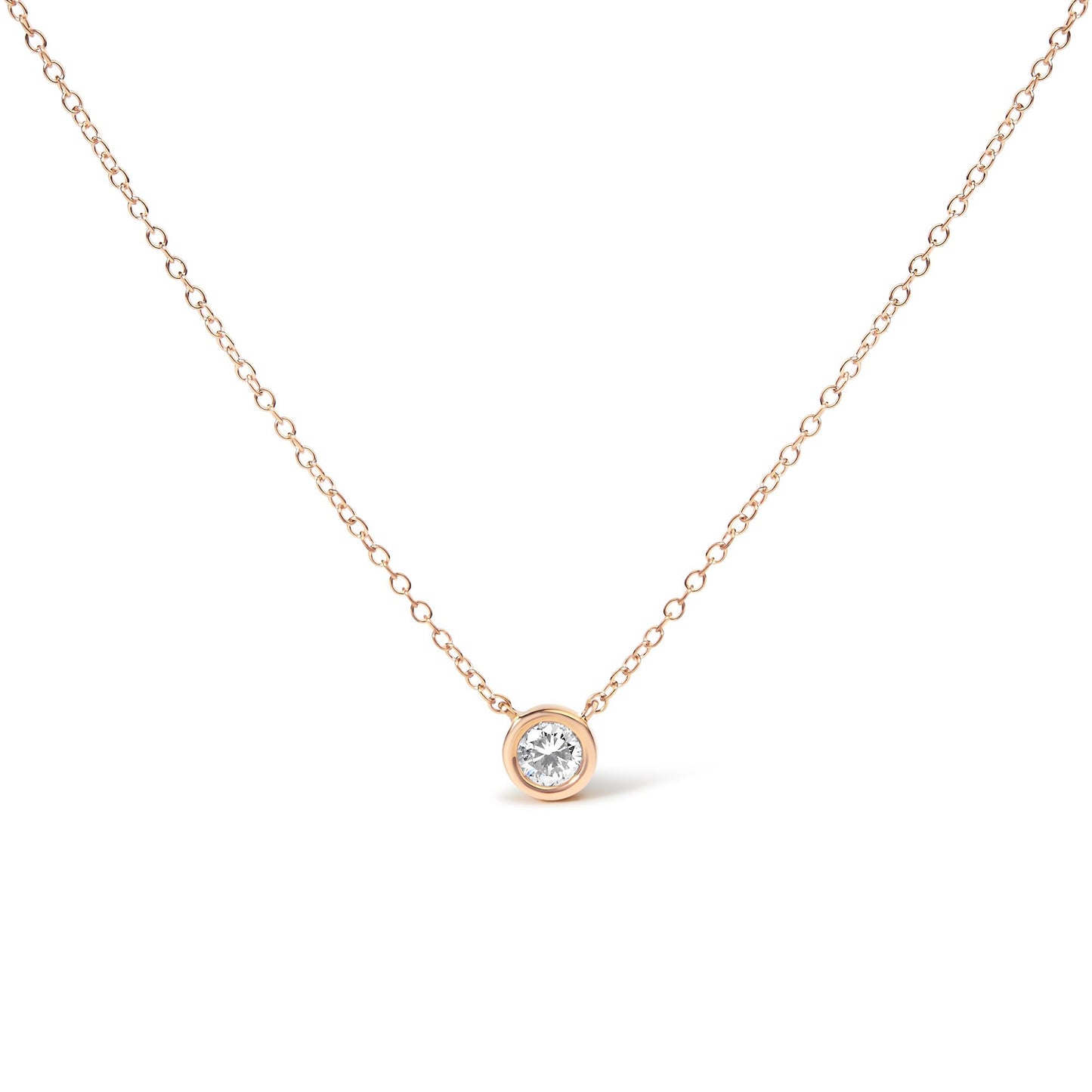 Front angle of a rose metal necklace with a single round white gemstone in a bezel setting pendant on a thin chain.