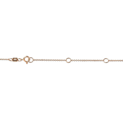 Rose metal necklace chain with round white gemstone in bezel setting, shown in a flat lay close-up shot.