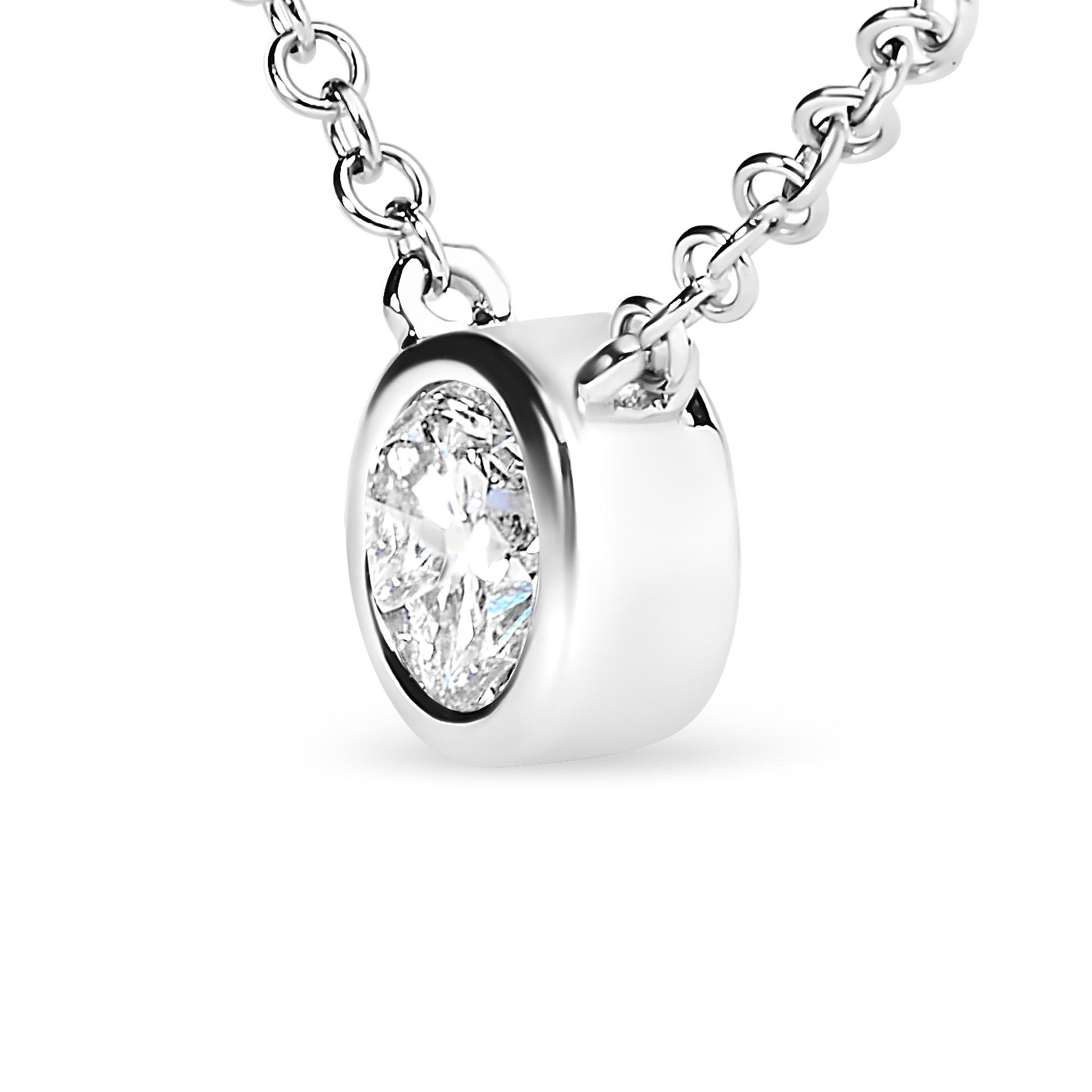 Close-up front angle of a white metal necklace featuring a single round white gemstone in a bezel setting on a chain.