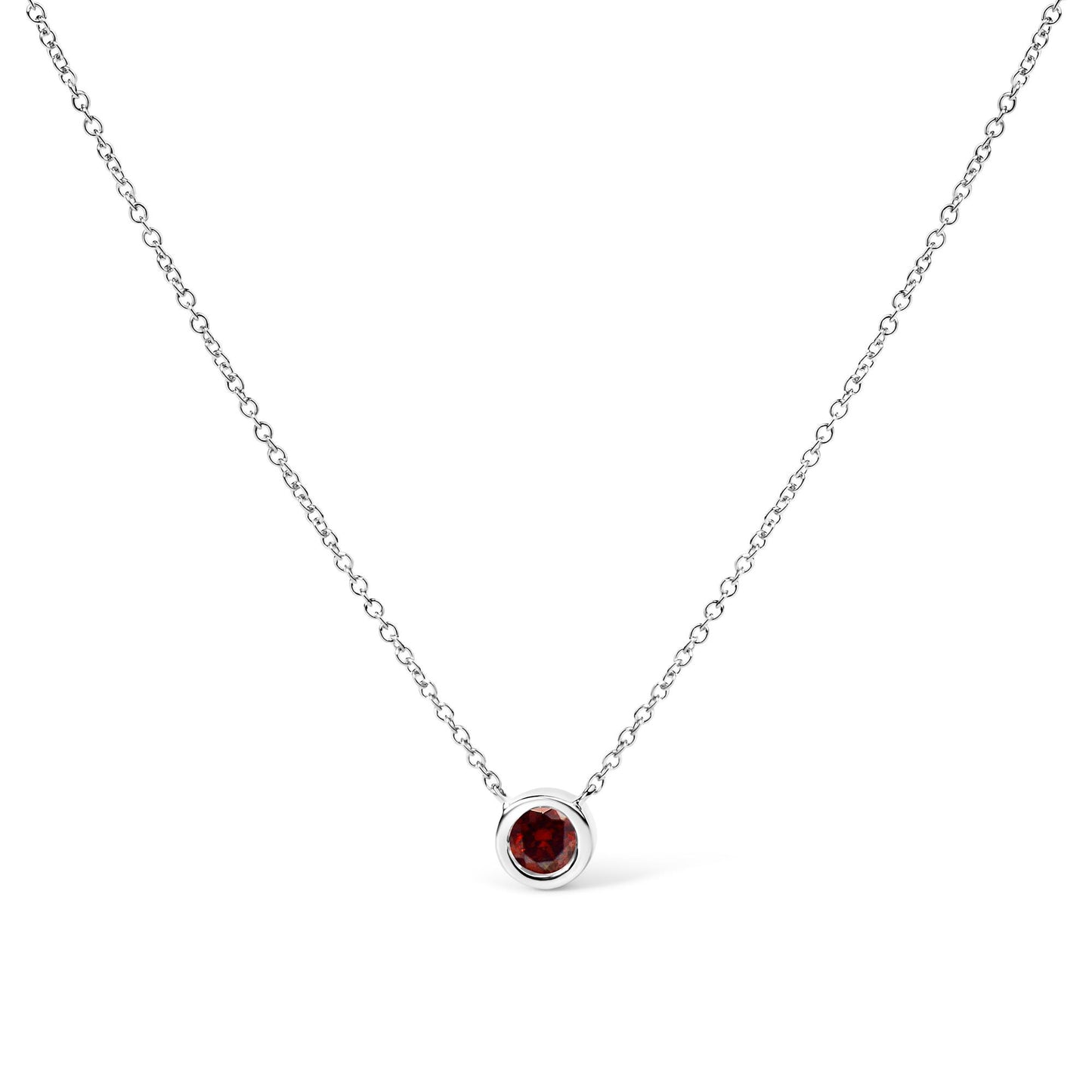 Front-facing shot of a white metal necklace with a round red gemstone in a bezel setting pendant.
