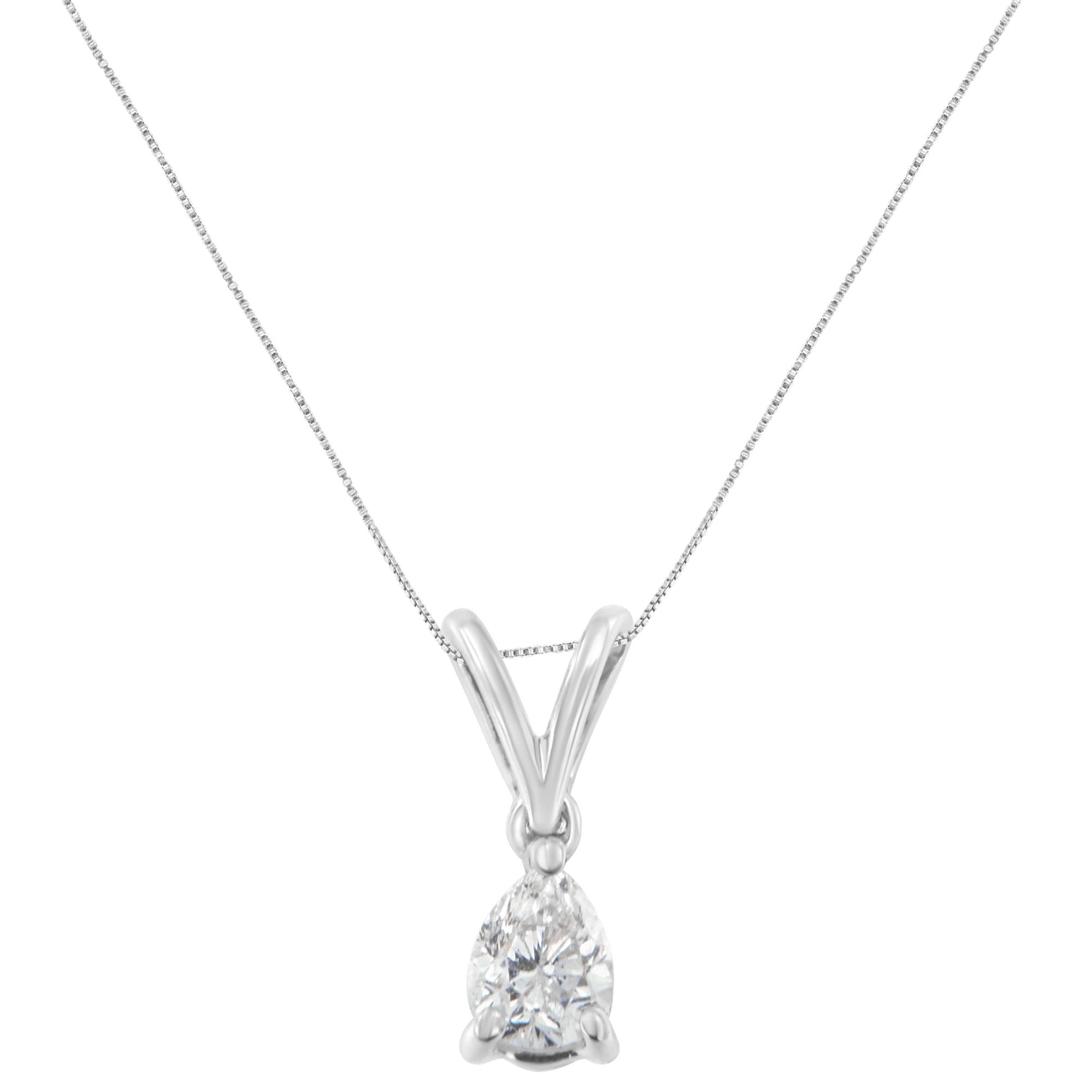 Front angle view of a white metal necklace with a pear-shaped white gemstone in a prong setting.