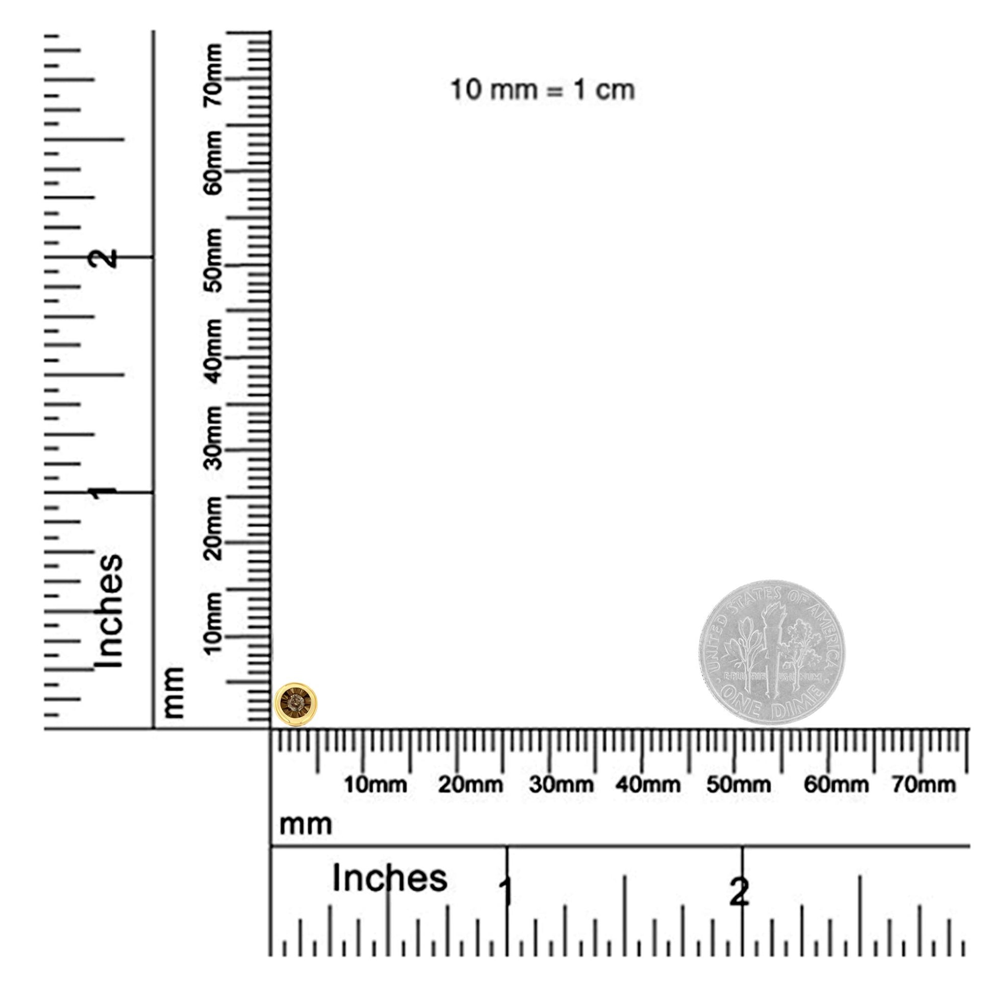 Close-up front view of a round brownish gemstone necklace pendant in miracle setting on a ruler for size reference.