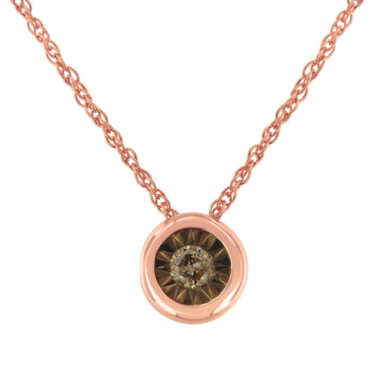 Close-up front view of a rose metal necklace with a round pendant featuring a central round champagne-colored gemstone in a miracle setting.