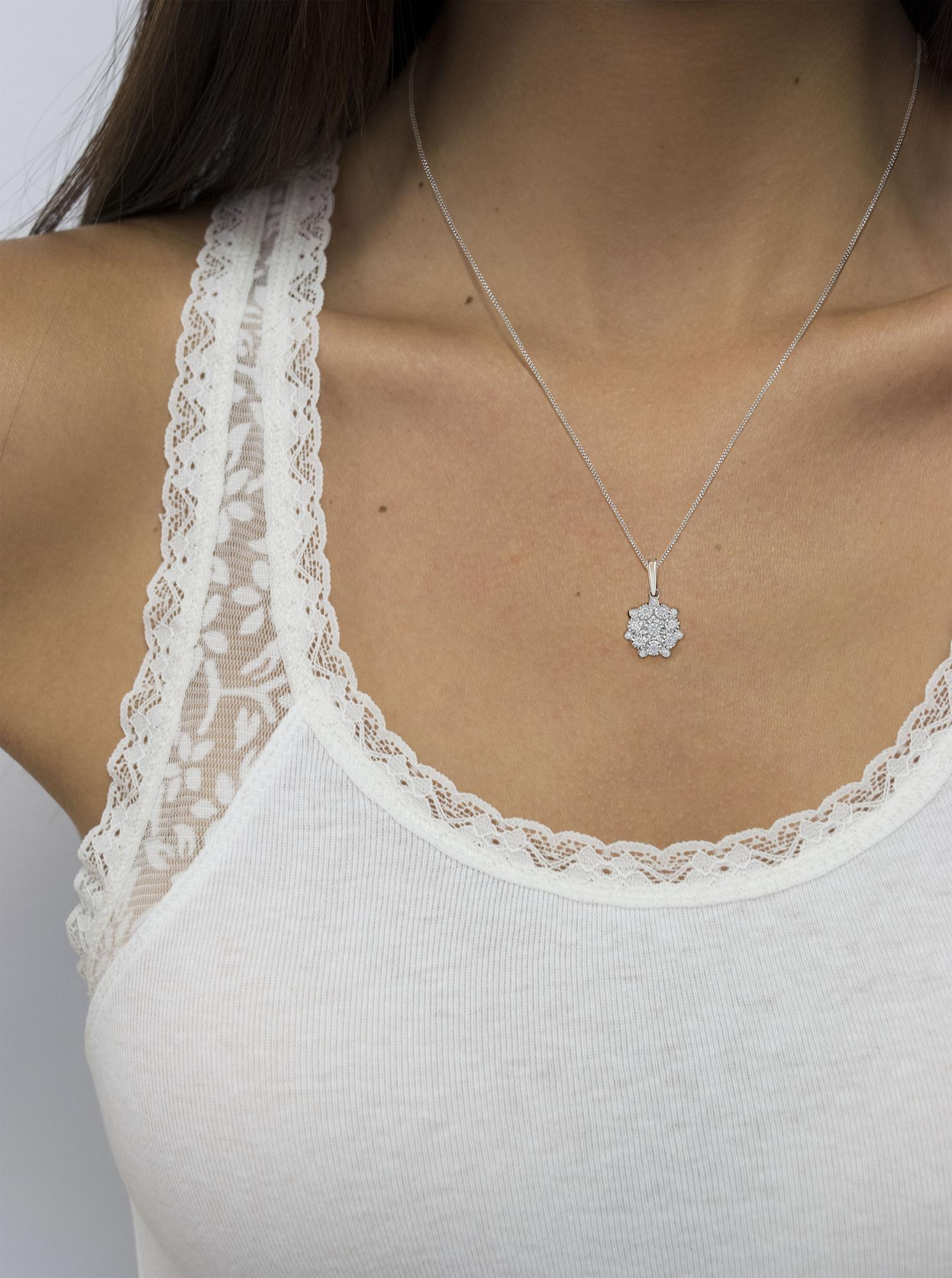 White metal necklace with a round cluster pendant of white gemstones in miracle settings, worn on a model, front view.