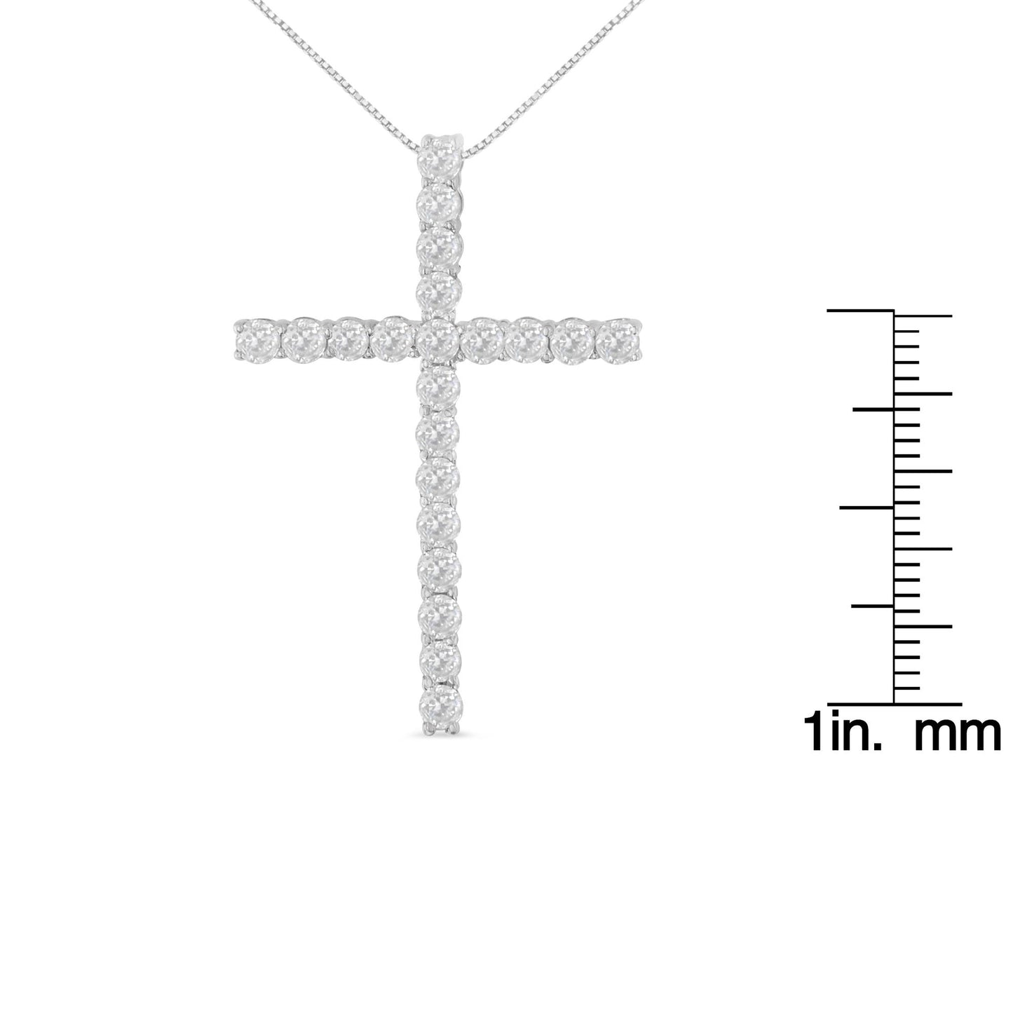 Front-facing image of a white necklace cross pendant with round white gemstones in prong settings, shown next to a ruler for size reference.