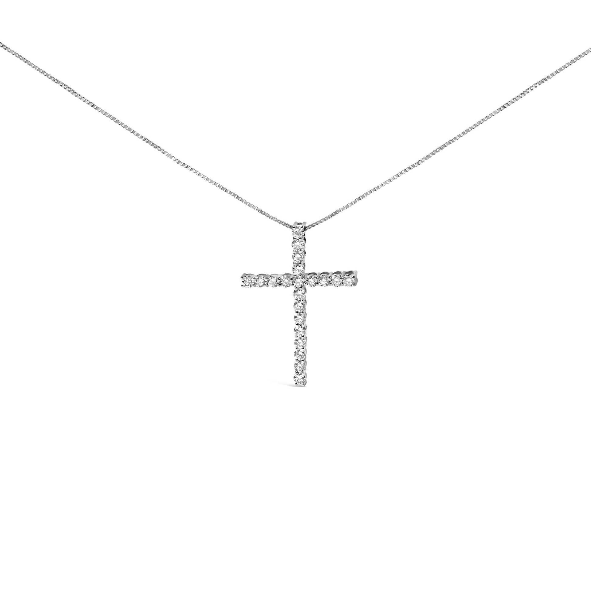 Front angle view of a white metal necklace with a cross pendant set with round white gemstones in a prong setting.