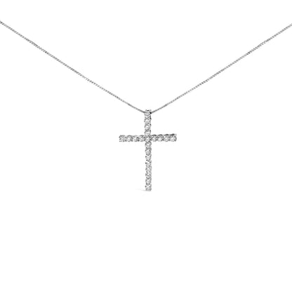 Front angle view of a white metal necklace with a cross pendant set with round white gemstones in a prong setting.
