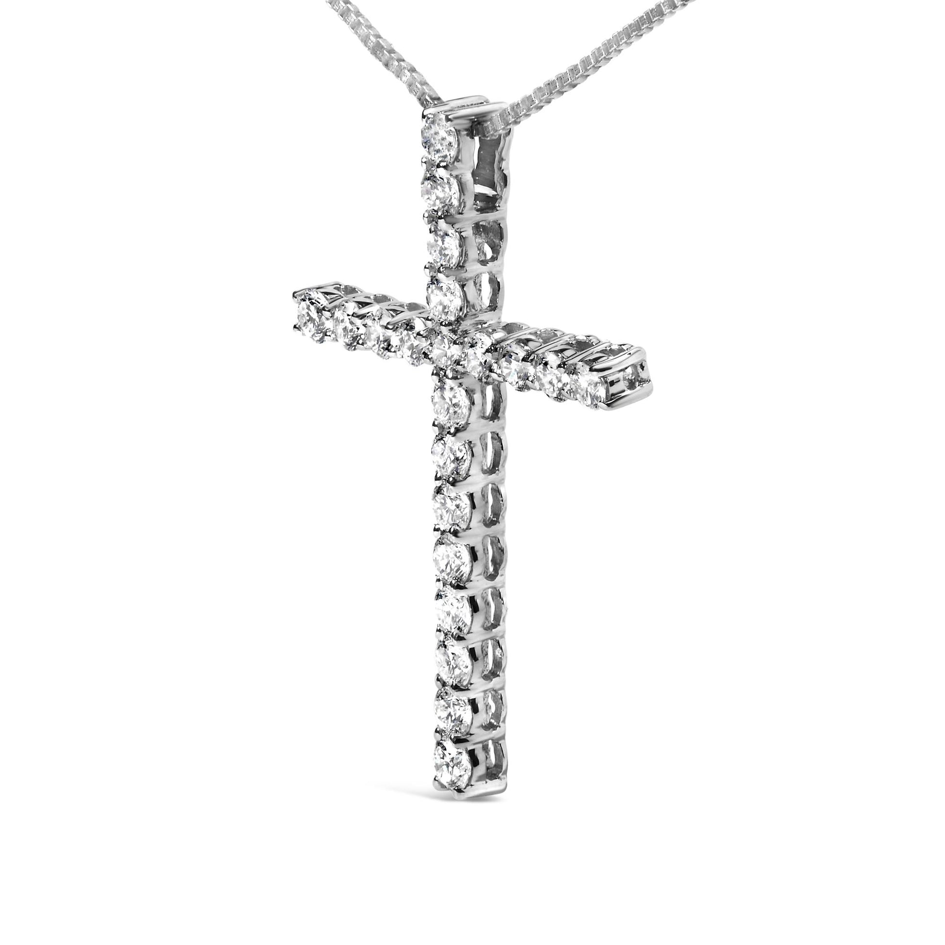Close-up front angle of a white metal cross necklace pendant with round white gemstones in prong settings along the vertical and horizontal bars.