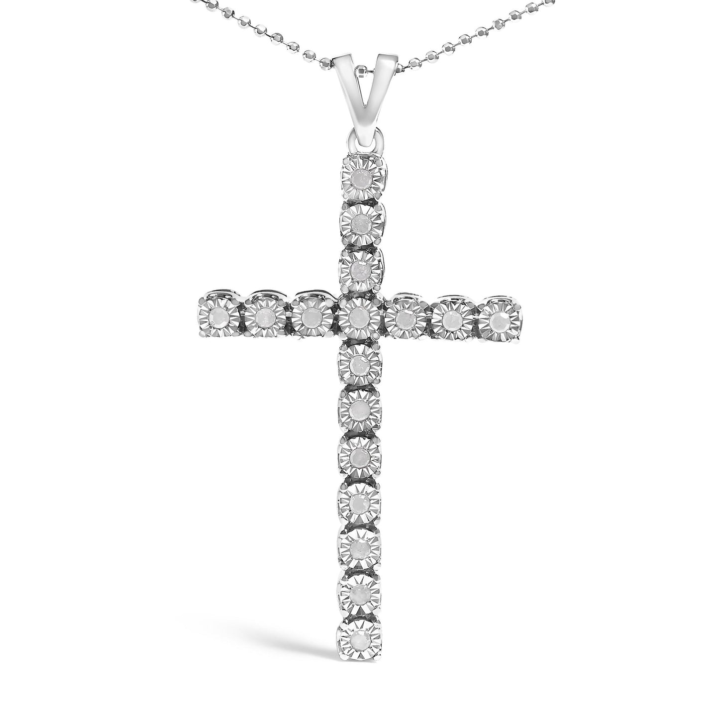 Front-facing shot of a white metal cross-shaped necklace pendant featuring round white gemstones in a miracle setting on a ball chain.