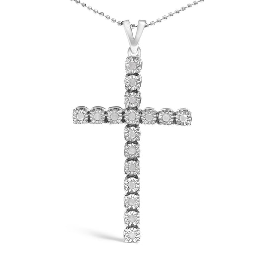 Front-facing shot of a white metal cross-shaped necklace pendant featuring round white gemstones in a miracle setting on a ball chain.