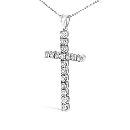 Front angled view of a white metal cross necklace pendant adorned with round white gemstones in a miracle setting, hanging from a beaded chain.