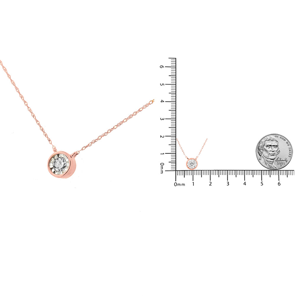 Rose metal necklace with a round white gemstone in a miracle setting, shown from a front angle, displayed next to a ruler and a coin for size reference.