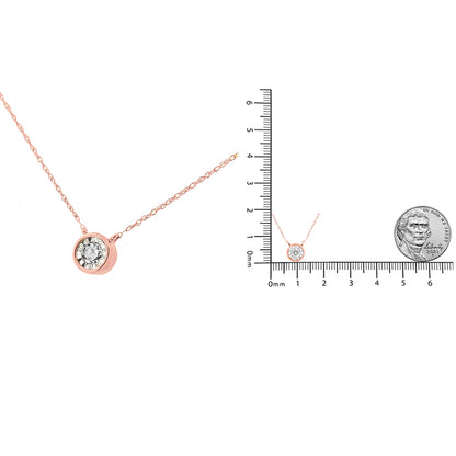 Rose metal necklace with a round white gemstone in a miracle setting, shown from a front angle, displayed next to a ruler and a coin for size reference.